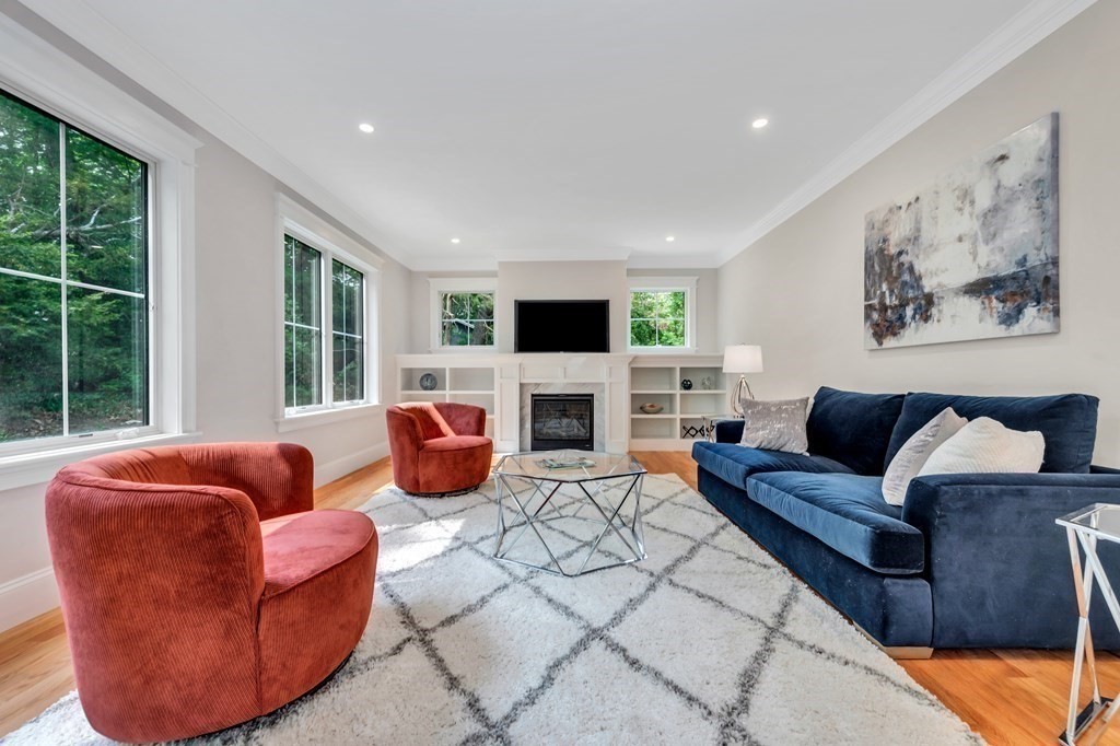 3 Crawford Road Lexington, MA 02420 - Photo 17 of 42 a living room with furniture a fireplace and a flat screen tv