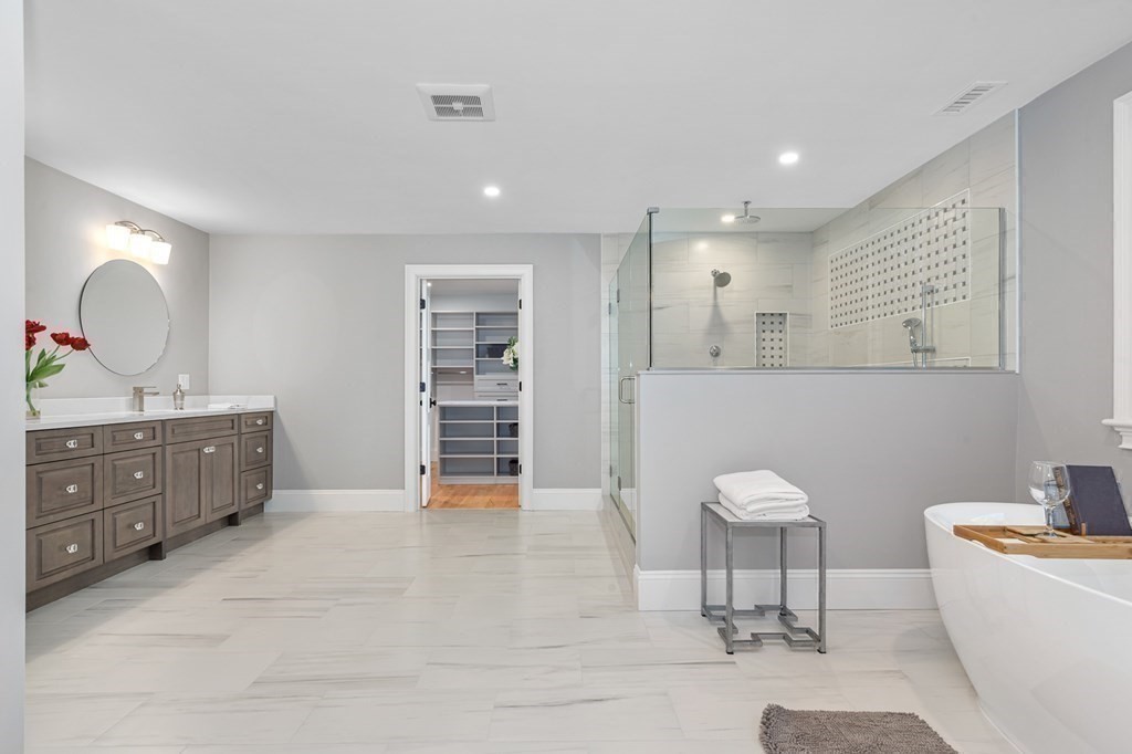 3 Crawford Road Lexington, MA 02420 - Photo 24 of 42 a spacious bathroom with a double vanity sink a mirror a bathtub and a toilet