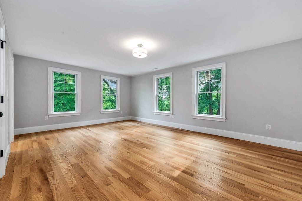 3 Crawford Road Lexington, MA 02420 - Photo 29 of 42 an empty room with wooden floor and windows