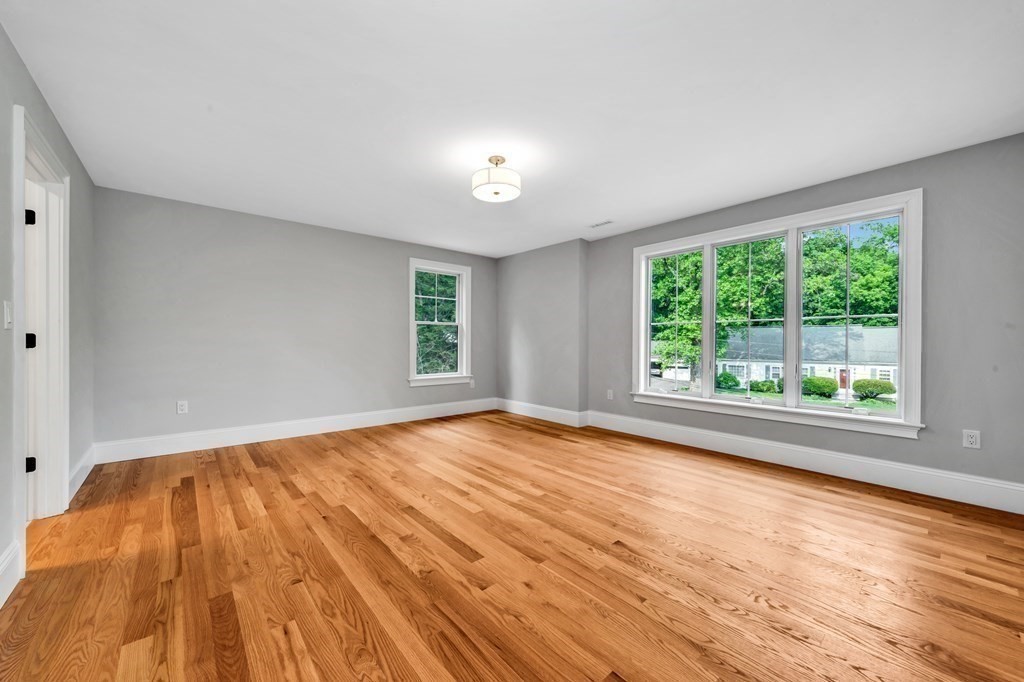 3 Crawford Road Lexington, MA 02420 - Photo 30 of 42 a view of an empty room with wooden floor and a window