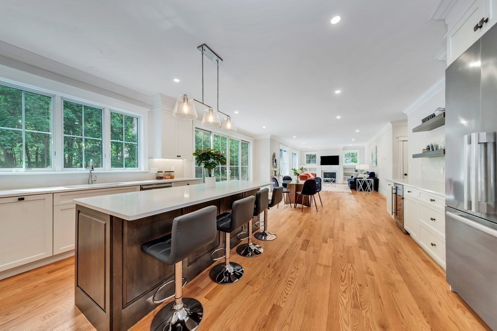 3 Crawford Road Lexington, MA 02420 - Photo 6 of 42 a kitchen with stainless steel appliances granite countertop a table chairs stove and a sink