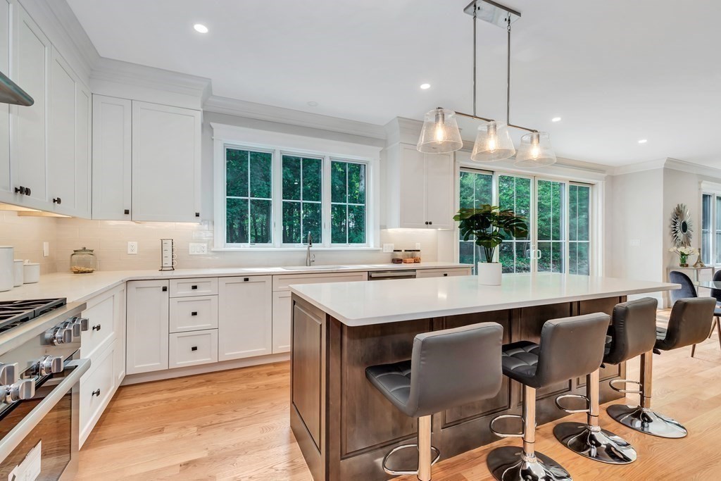 3 Crawford Road Lexington, MA 02420 - Photo 7 of 42 a kitchen with a stove a sink a window and chairs