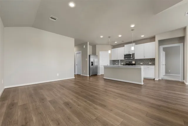 a view of a kitchen with a sink and a stove top oven