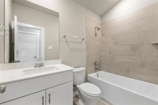 a bathroom with a sink a toilet and bathtub