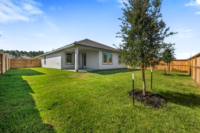 a view of a house with a yard and a garden
