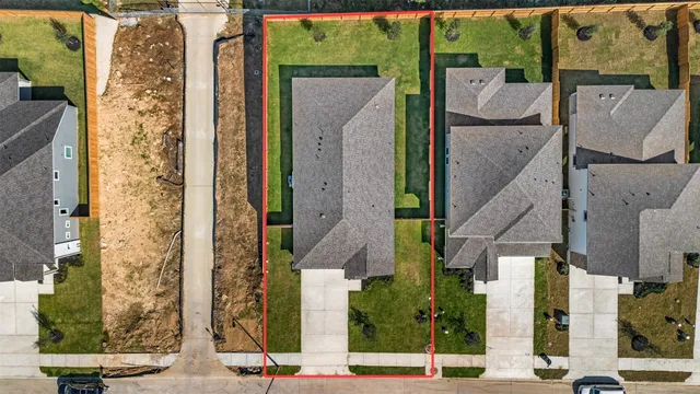 an aerial view of houses with street