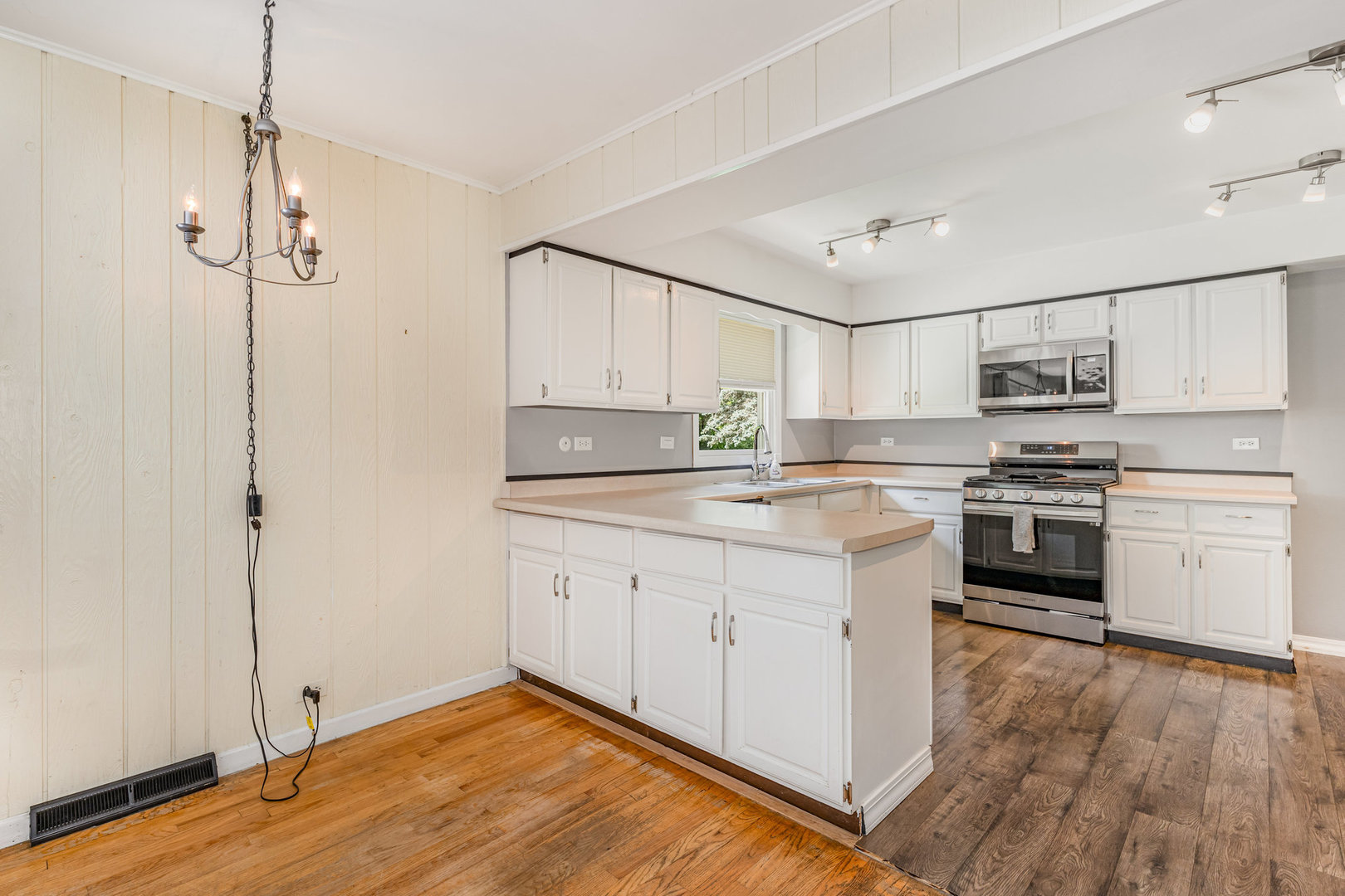158 South Ela Road Barrington, IL 60010 - Photo 5 of 21 a kitchen with stainless steel appliances a stove a sink and white cabinets