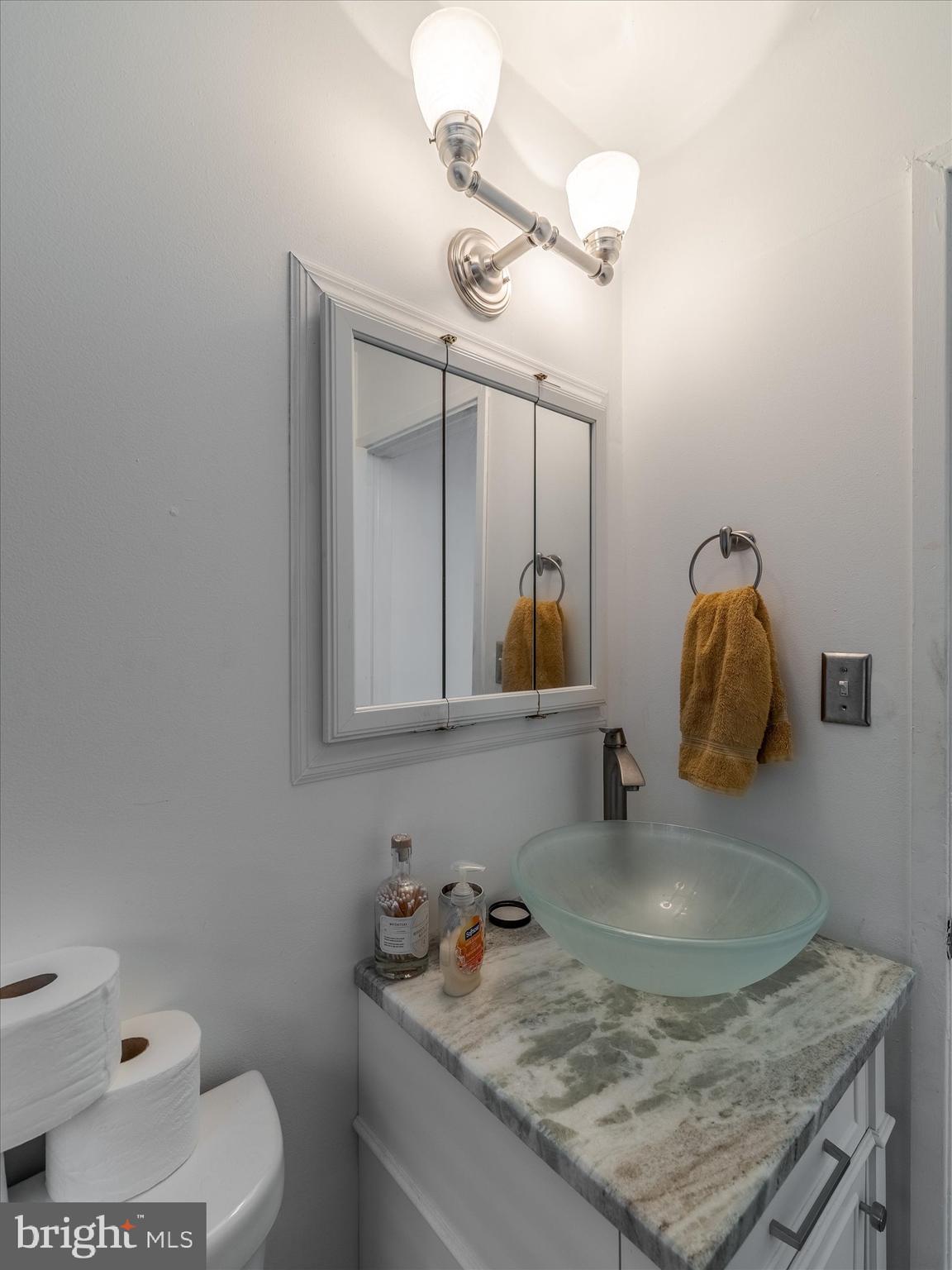 1108 Locust Street Philadelphia, PA 19107 - Photo 11 of 15 a bathroom with a granite countertop sink and a mirror
