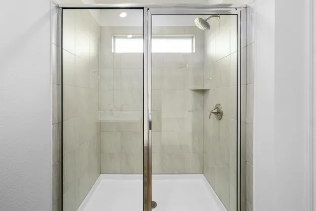 a bathroom with a glass shower door