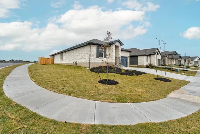 an aerial view of a house with swimming pool and mountains