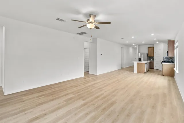 a view of a kitchen with a sink and a refrigerator