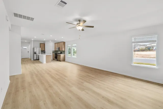 a view of a kitchen with a sink and a stove top oven