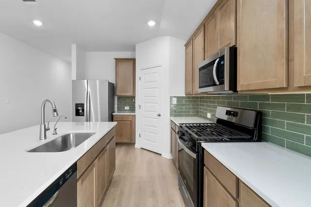 a kitchen that has a sink and a stove