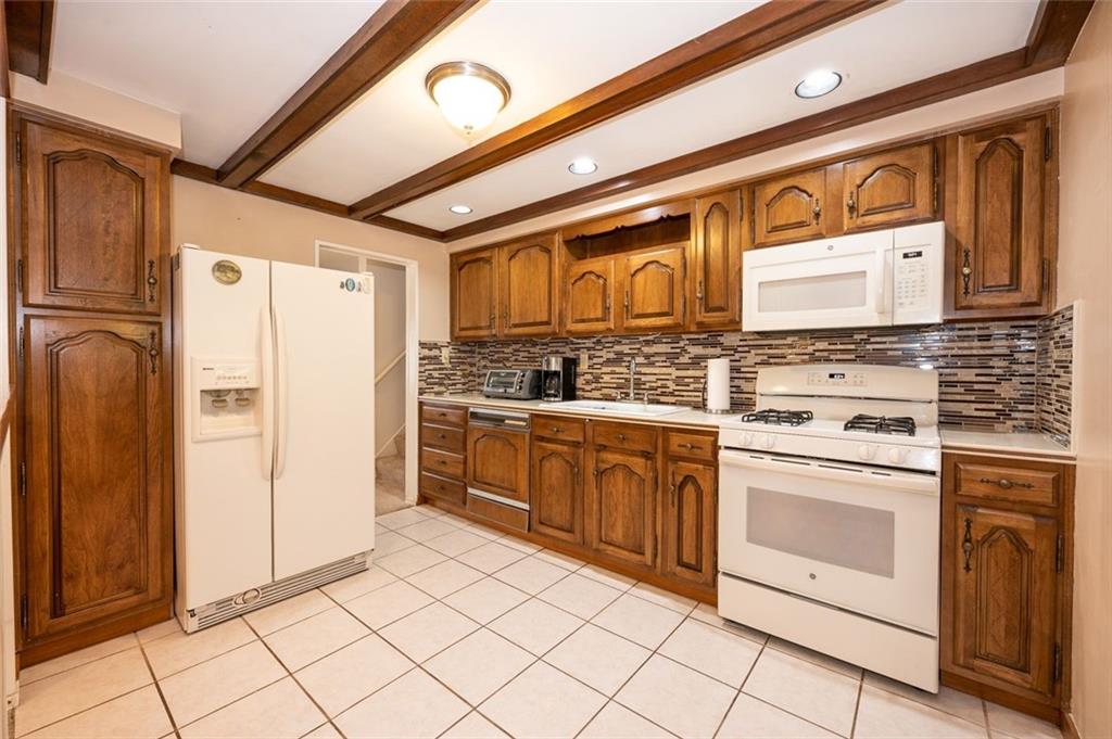 1342 Cathell Road Pittsburgh, PA 15236 - Photo 3 of 31 a kitchen with stainless steel appliances granite countertop a stove and a refrigerator