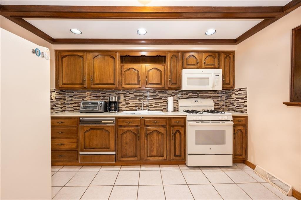 1342 Cathell Road Pittsburgh, PA 15236 - Photo 4 of 31 a bathroom with a granite countertop sink a mirror and a bathtub
