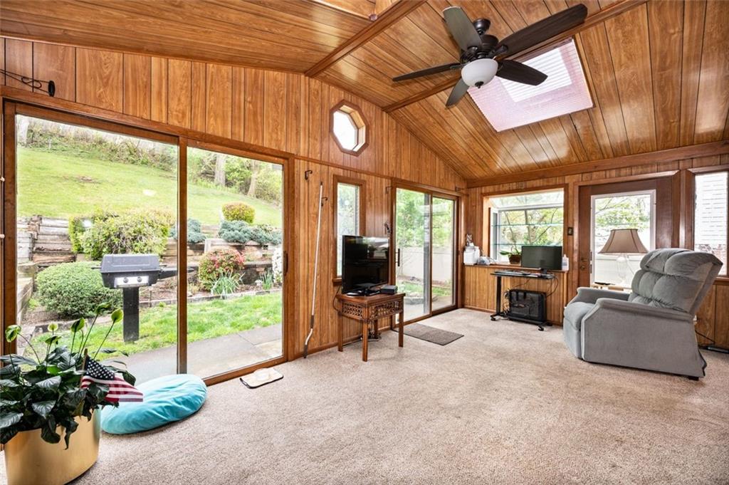 1342 Cathell Road Pittsburgh, PA 15236 - Photo 7 of 31 a living room with furniture a flat screen tv and floor to ceiling window