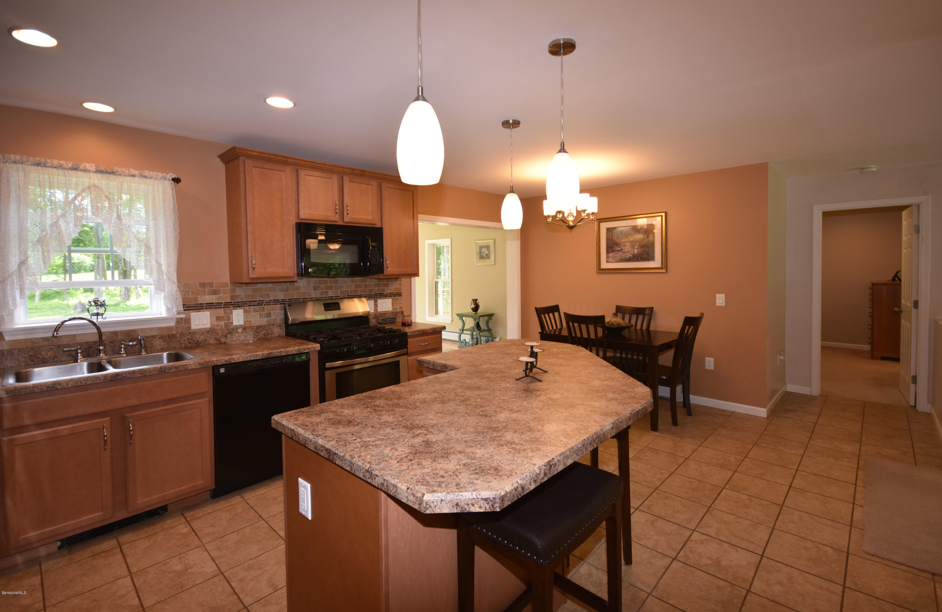 205 Windsor Road Savoy, MA 01256 - Photo 11 of 53 a kitchen with granite countertop a stove a sink a dining table and chairs