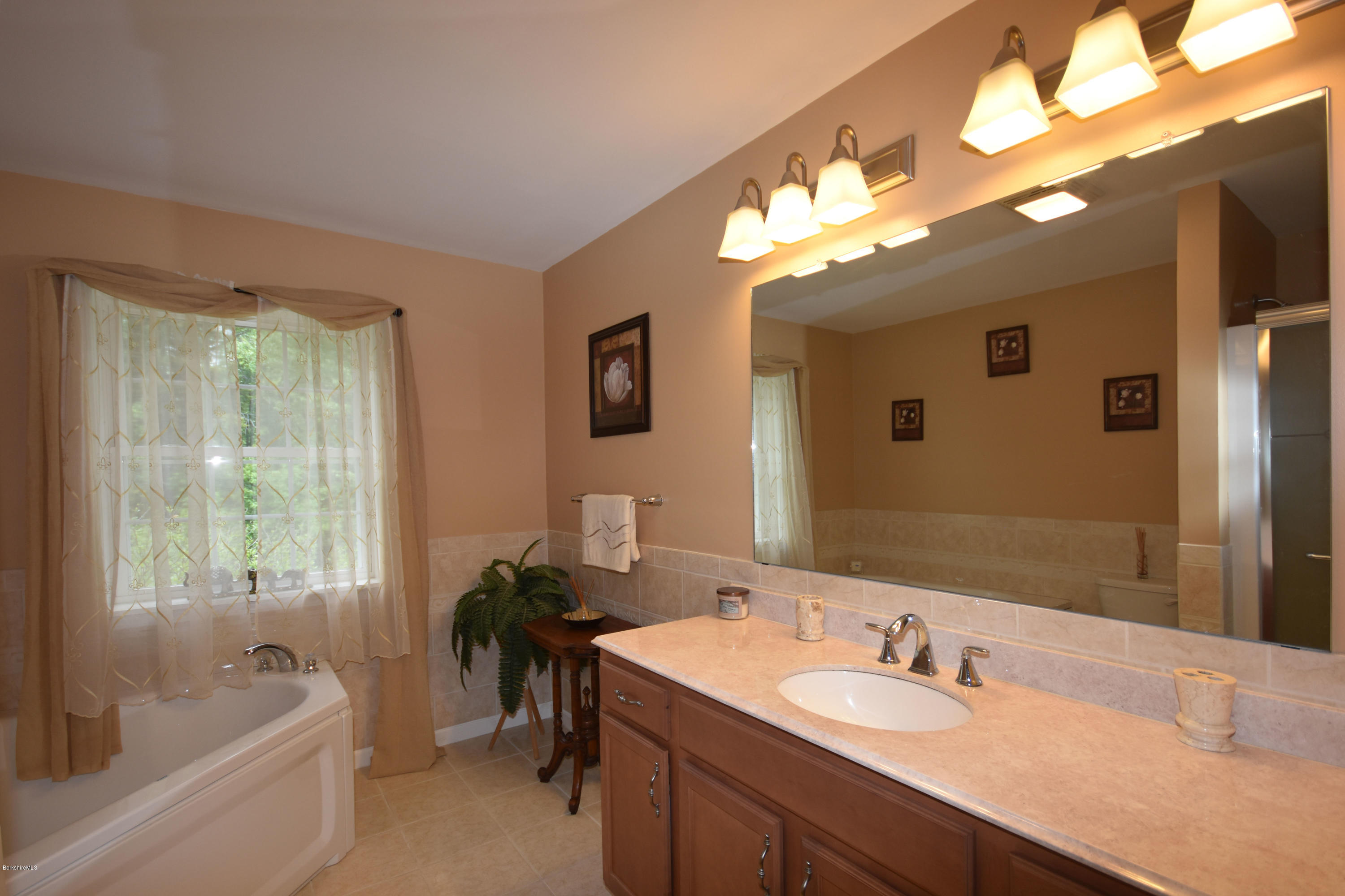 205 Windsor Road Savoy, MA 01256 - Photo 24 of 53 a bathroom with a tub sink and mirror