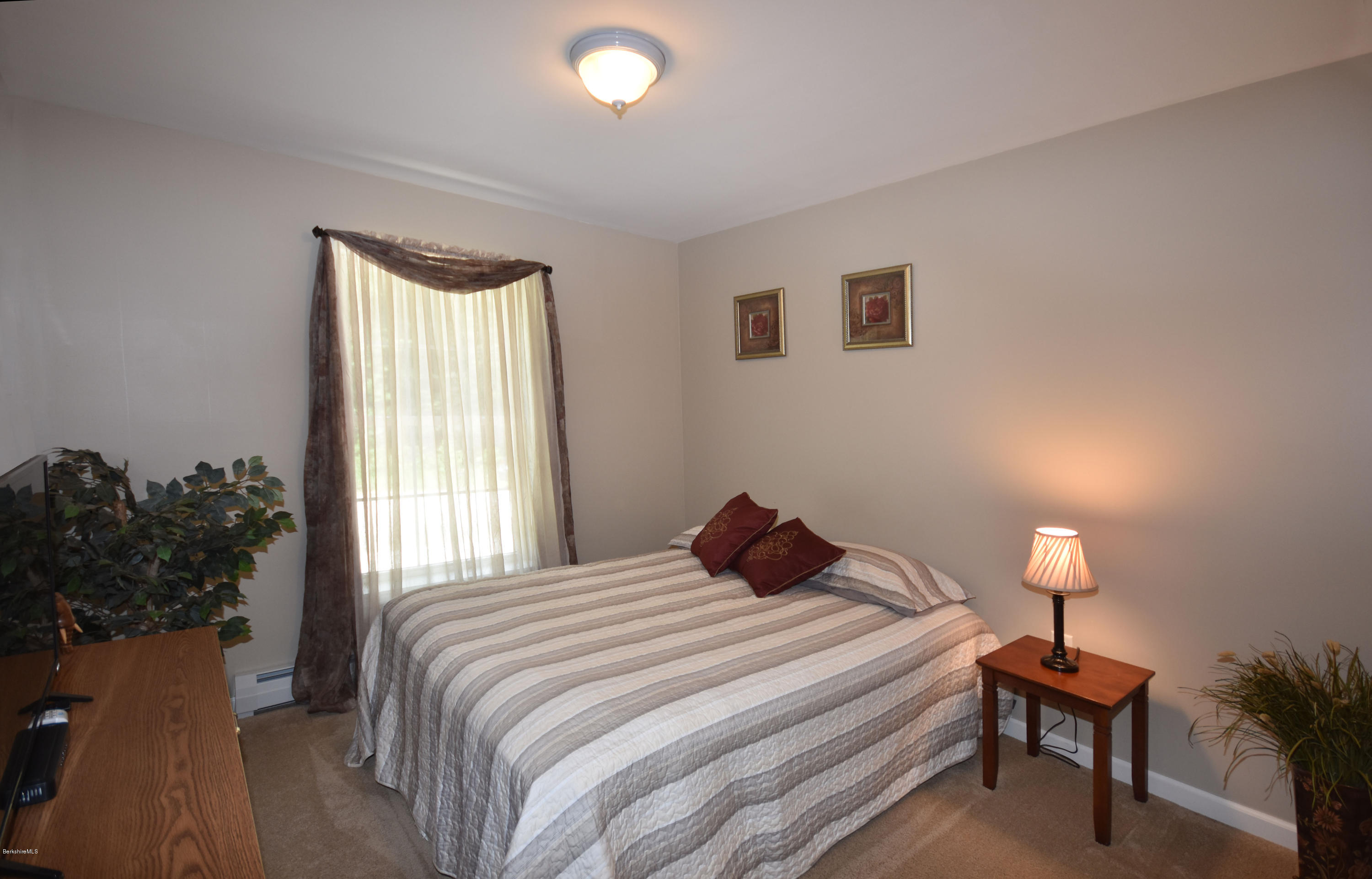 205 Windsor Road Savoy, MA 01256 - Photo 27 of 53 a bedroom with a bed and a lamp next to a window