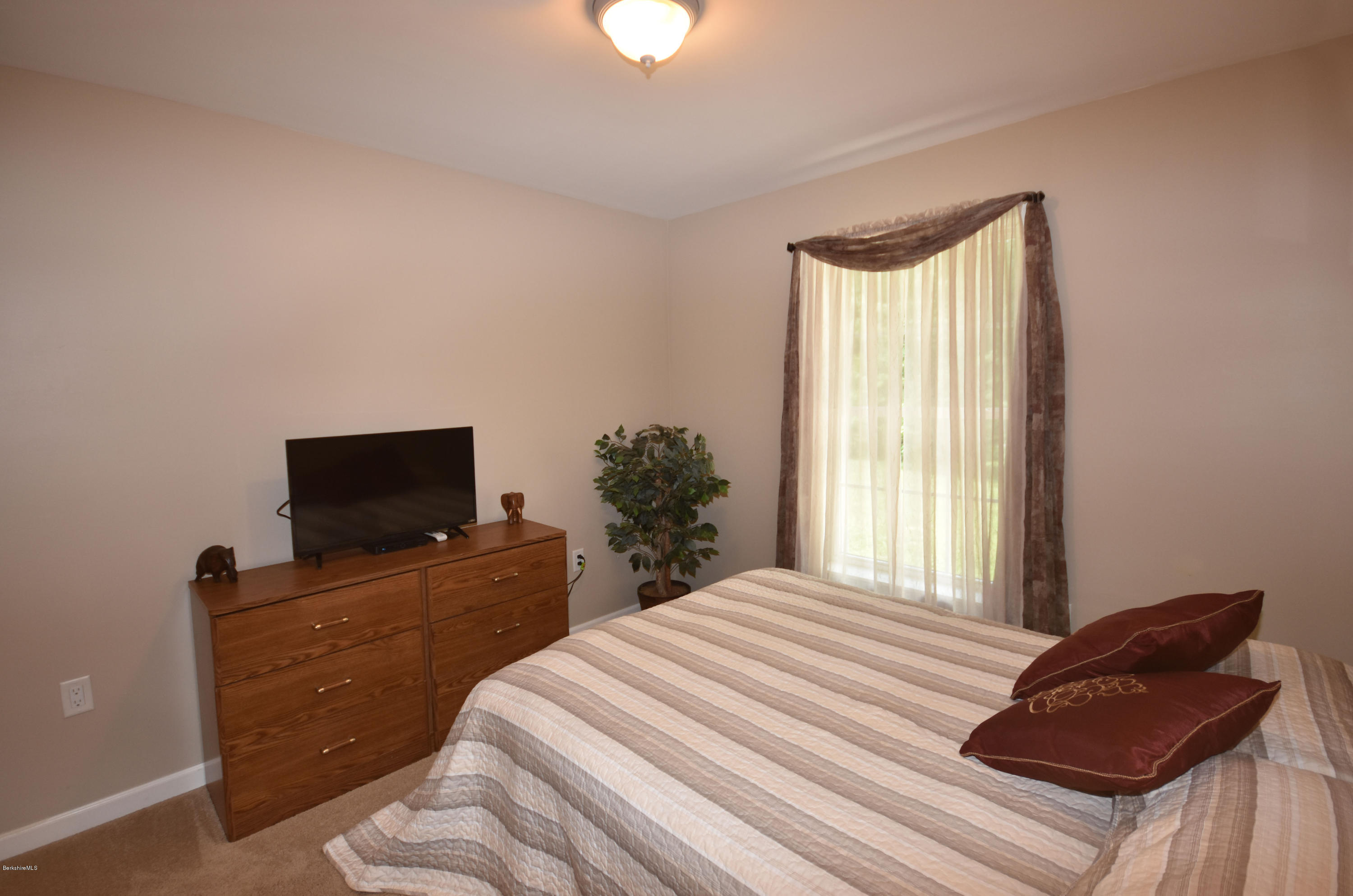 205 Windsor Road Savoy, MA 01256 - Photo 28 of 53 a bedroom with a bed and flat screen tv