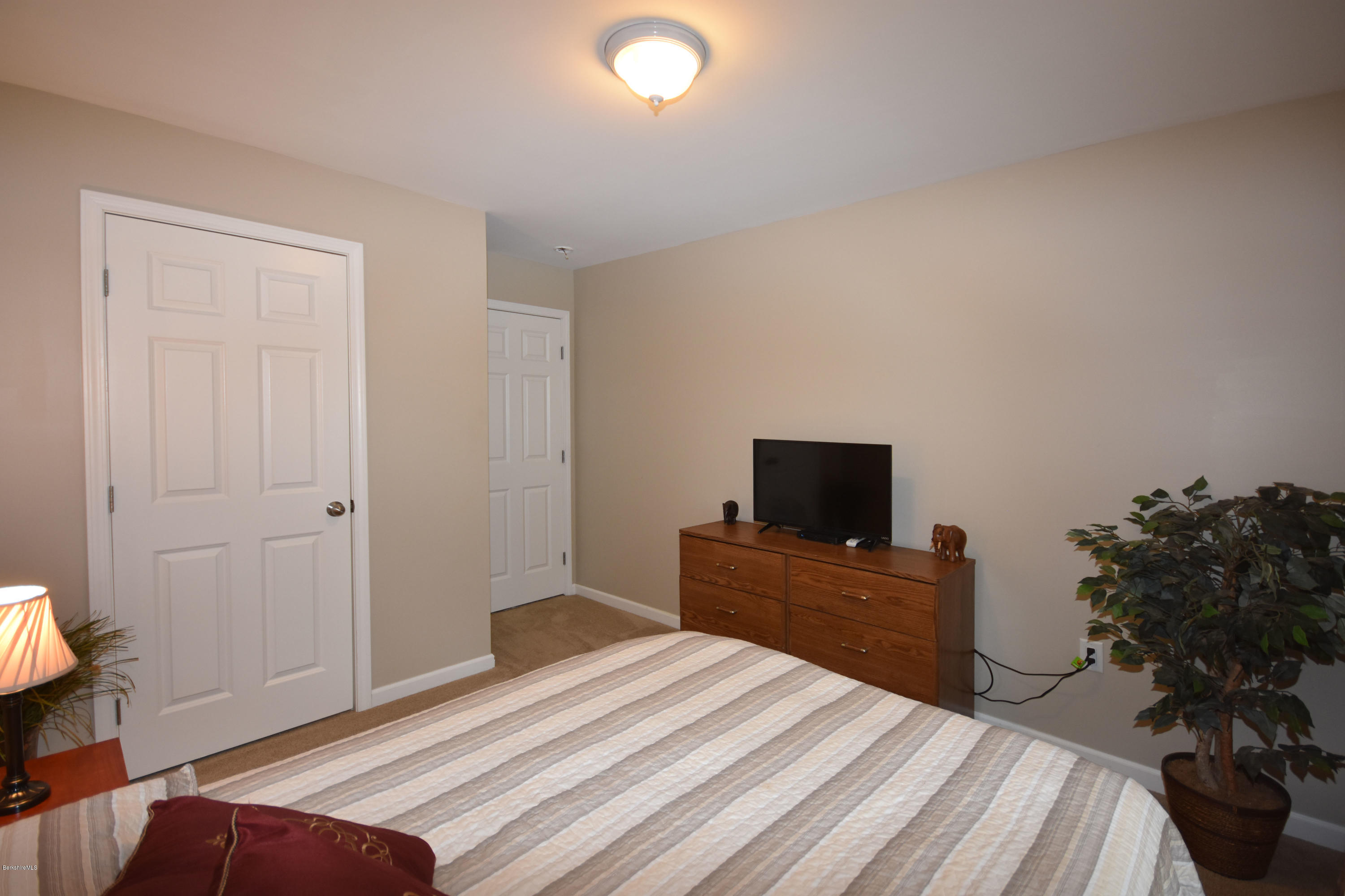 205 Windsor Road Savoy, MA 01256 - Photo 30 of 53 a bedroom with a bed and a flat tv screen on dresser