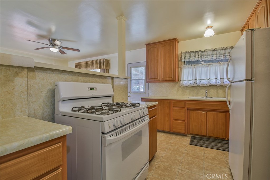15719 Pitts Avenue Paramount, CA 90723 - Photo 13 of 33 a kitchen with a stove and a sink
