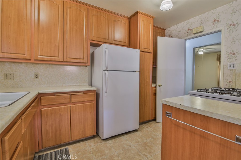 15719 Pitts Avenue Paramount, CA 90723 - Photo 14 of 33 a kitchen with stainless steel appliances granite countertop a refrigerator a stove and a sink