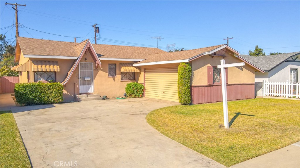 15719 Pitts Avenue Paramount, CA 90723 - Photo 2 of 33 a front view of a house with a yard