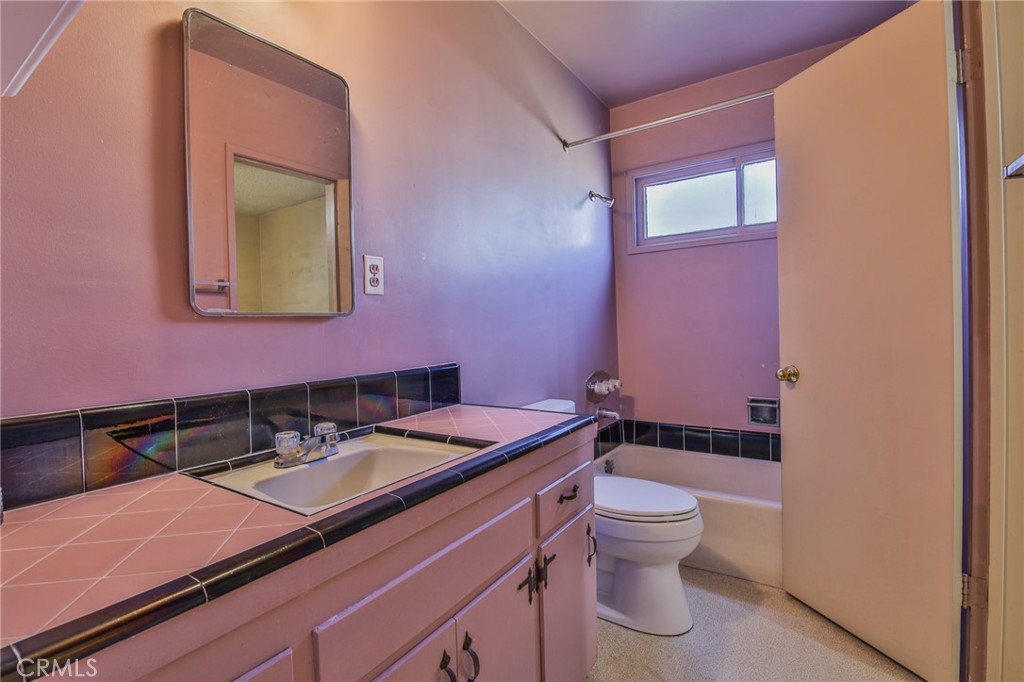 15719 Pitts Avenue Paramount, CA 90723 - Photo 21 of 33 a bathroom with a sink a toilet and mirror