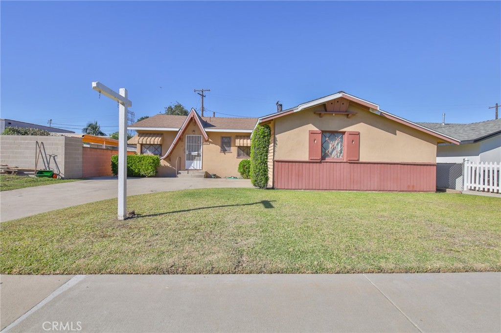 15719 Pitts Avenue Paramount, CA 90723 - Photo 3 of 33 a front view of a house with garden