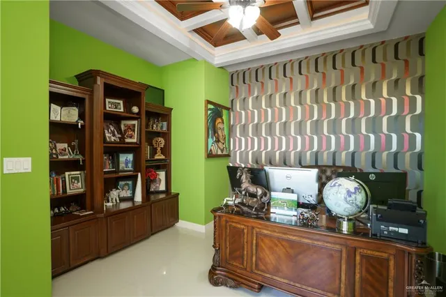 a living room with fish tank and a bookshelf