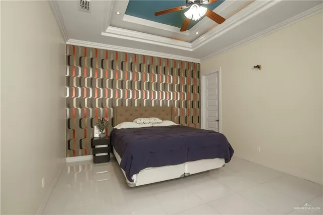 a bedroom with a bed and a chandelier