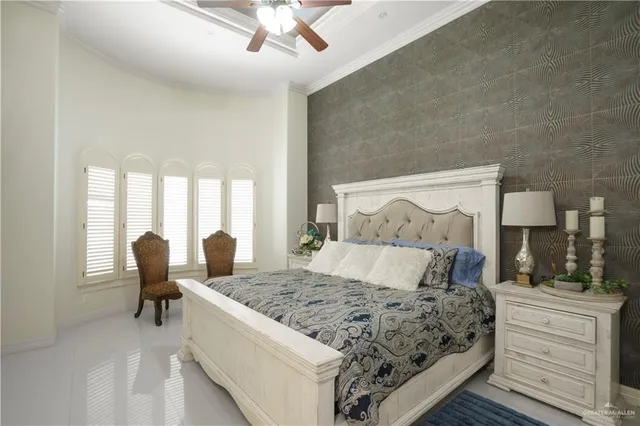 a bedroom with a large bed and a window