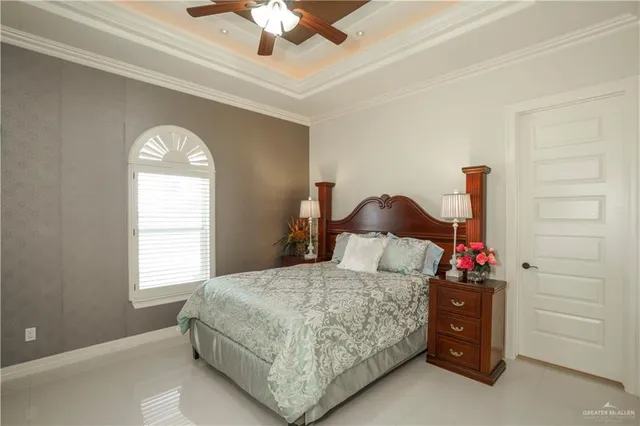 a bedroom with a bed and a chandelier