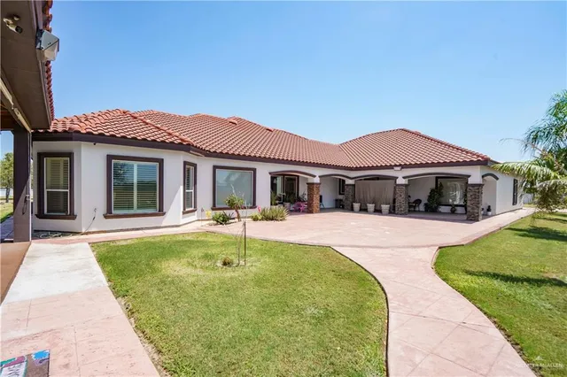 a front view of a house with swimming pool having outdoor seating
