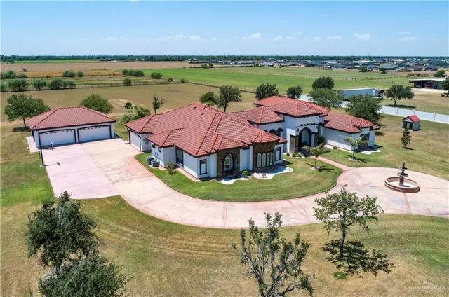 an aerial view of a house with garden space and outdoor seating
