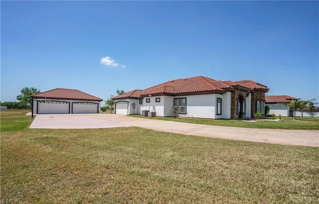 a front view of a house with a yard and balcony