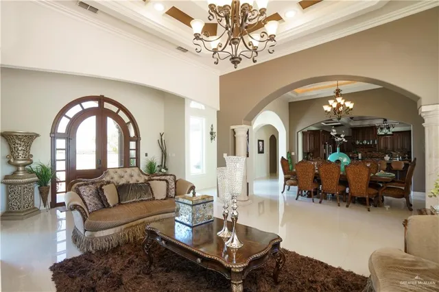 a living room with furniture and a chandelier