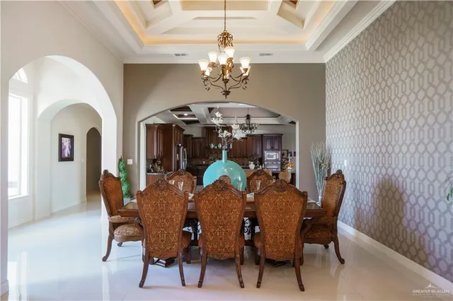 a view of a dining room with furniture and chandelier