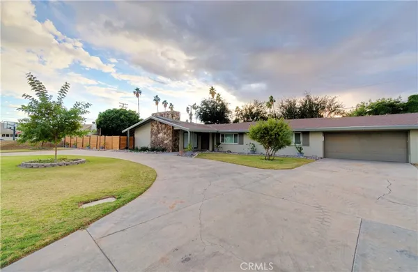 a view of a house with pool and a yard