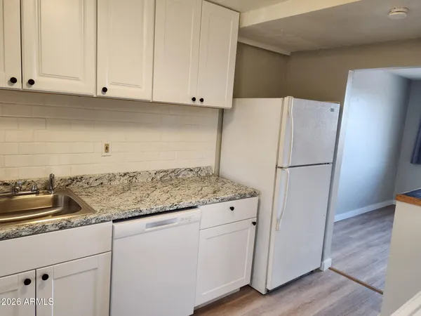 a kitchen with appliances cabinets and a counter space
