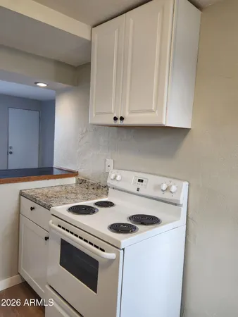 a white stove top oven sitting inside of a kitchen