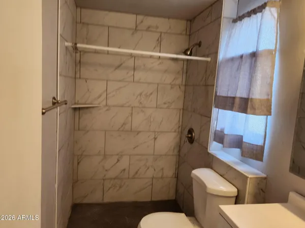 a bathroom with a toilet and shower