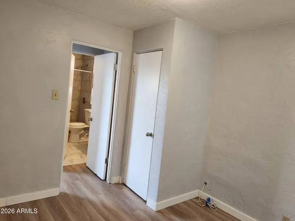 a view of room with window and wooden floor
