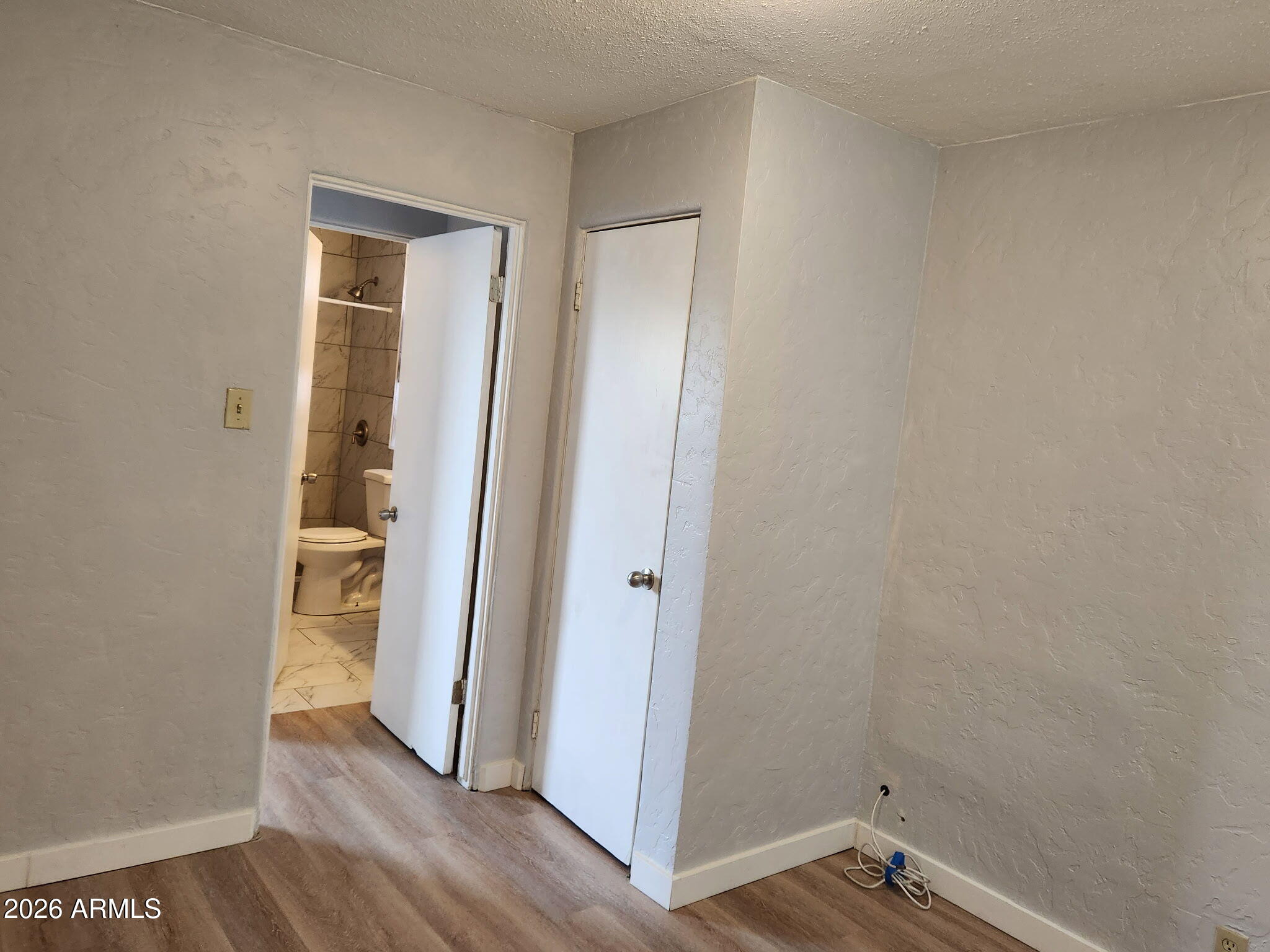 1517 West Thomas Road, Unit 3 Phoenix, AZ 85015 - Photo 8 of 14 a view of room with window and wooden floor
