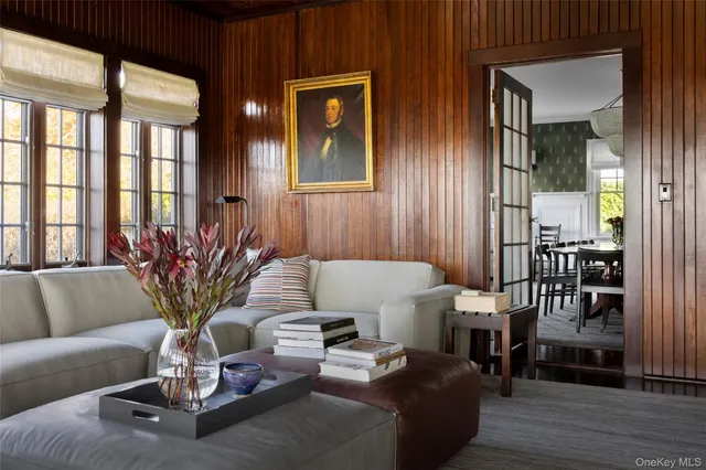 a living room with furniture flowerpot and wooden floor