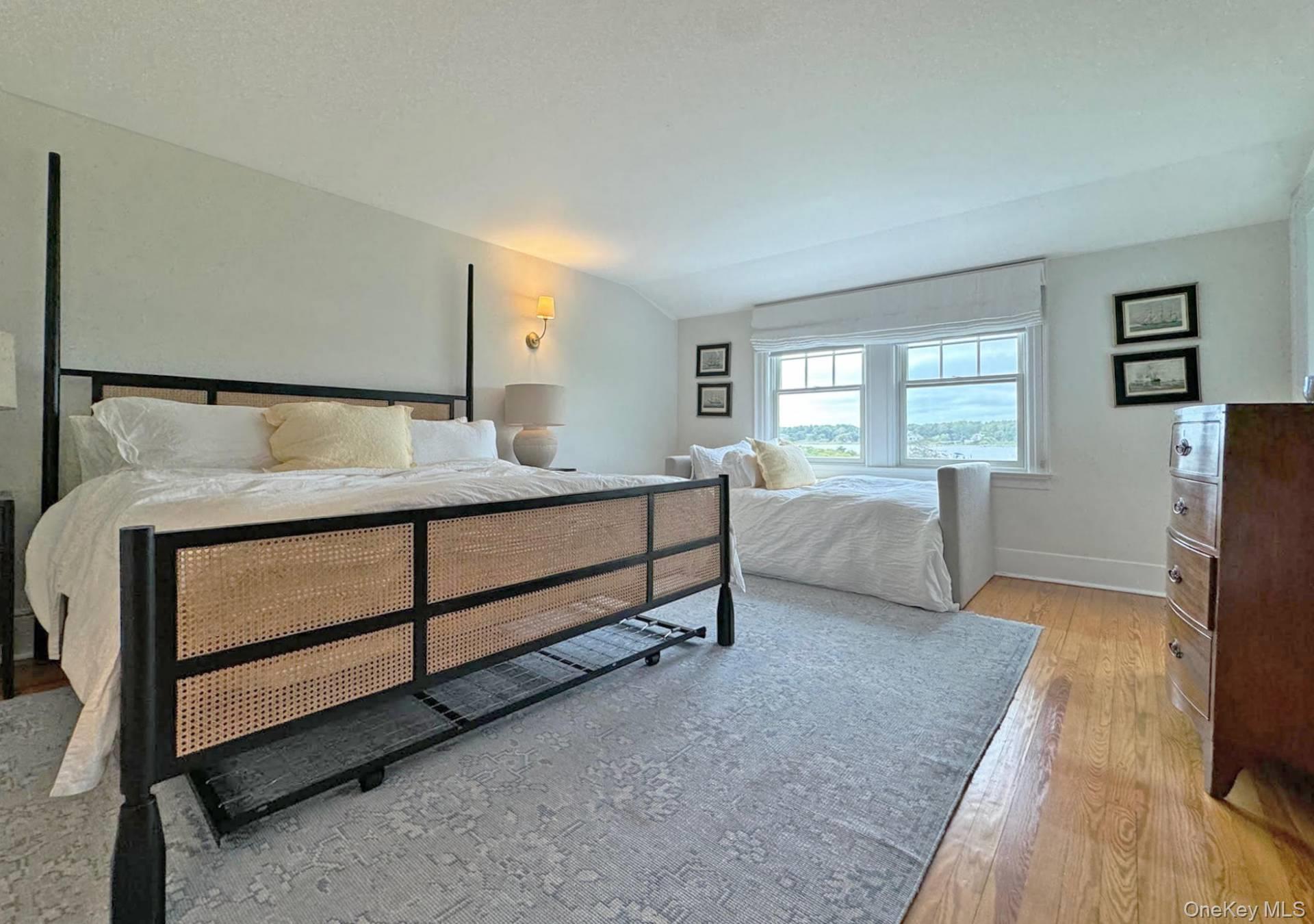 4 Sandacres Road Quogue, NY 11959 - Photo 18 of 32 a bedroom with a bed and large windows