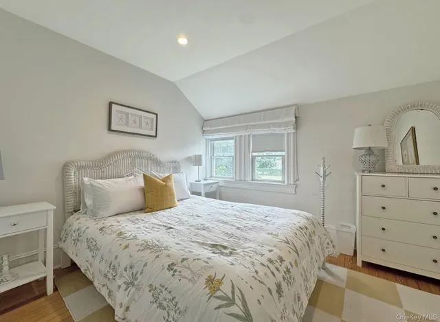 a large bed sitting in a bedroom and a dresser