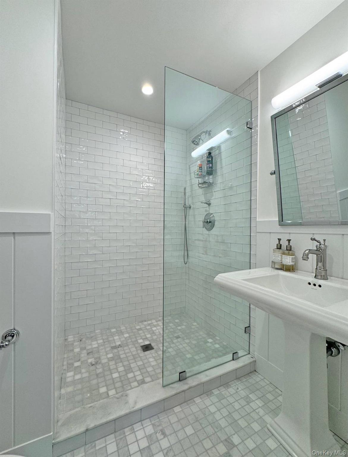 4 Sandacres Road Quogue, NY 11959 - Photo 23 of 32 a bathroom with a shower sink and mirror