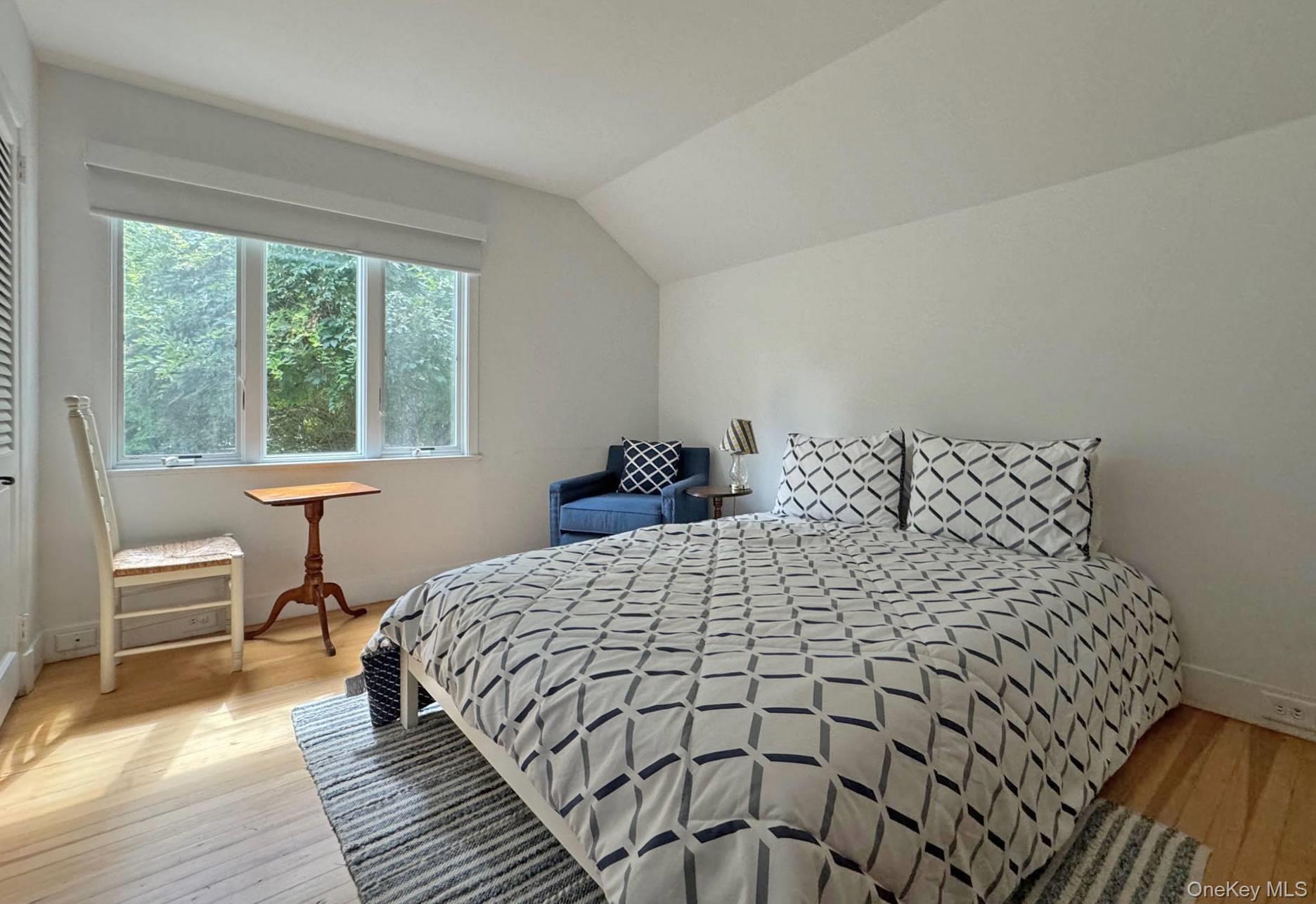 4 Sandacres Road Quogue, NY 11959 - Photo 24 of 32 a bedroom with a bed and a table chair